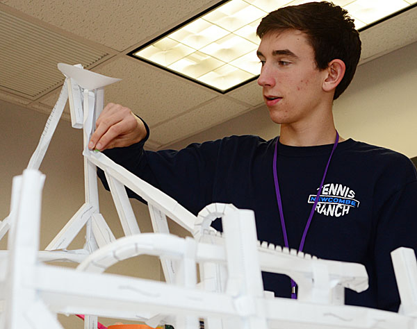 Junior Nicholas Cromwell prepares a marble for his roller coaster project. Photo by Nate Beer