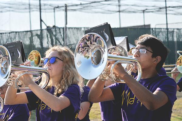 Junior Autumn Strange marches to the beat while playing the mellophone.
Photo by Travis Pokorney