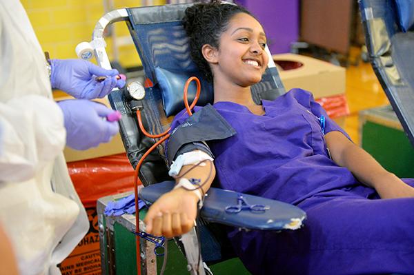 Junior Harena Yemane smiles as her blood is drawn for the Carter BloodCare blood drive. Photo by Fidelia Nawar