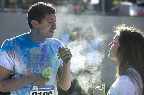 Photo by Ryan Durbin
Freshman Nathan Hernandez  and sophomore Eleanor Mccabe throw paint at each other after finishing the color run.