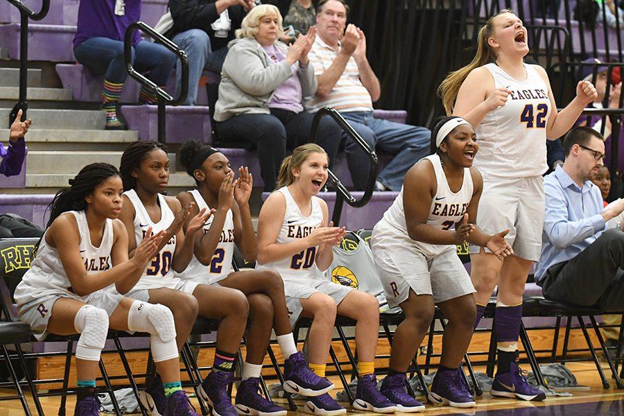 The girls varsity basketball team cheers during a successful game against Coppell last Friday. Photo by Madison Staggenborg