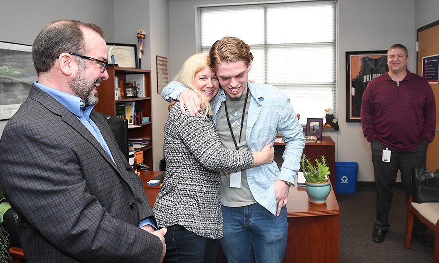 After hearing the news that he was appointed to the United States Merchant Marine Academy, Patrick Mishler congradulates by his mom Elaine Mishler with his Father Randy Misher and head Principal Chris Choat looking on.  photo by Chad Byrd