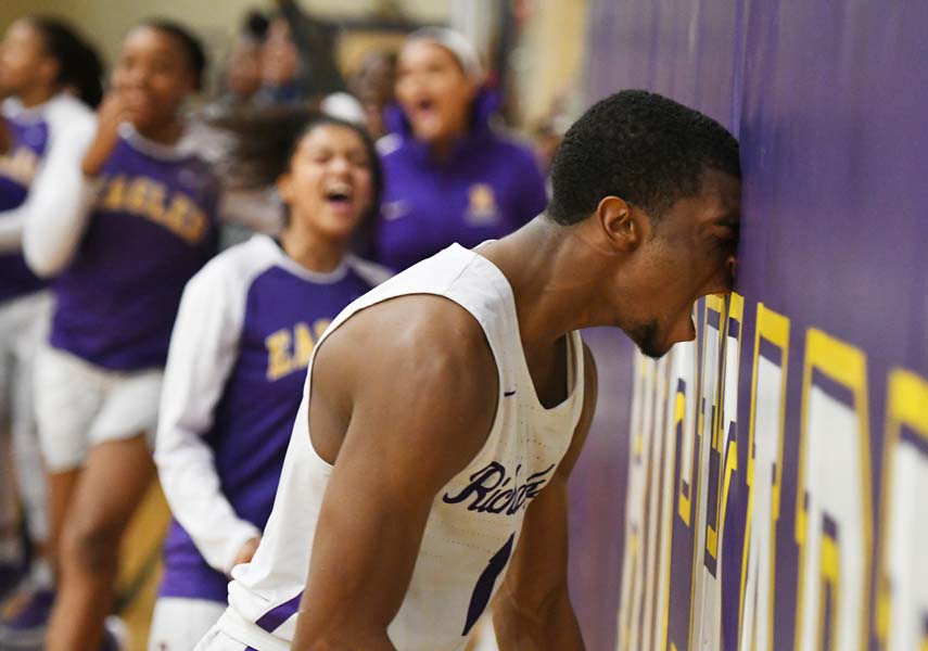 Senior Jalen Patterson celebrates after putting in a last second bucket for the win in overtime over Rowlett