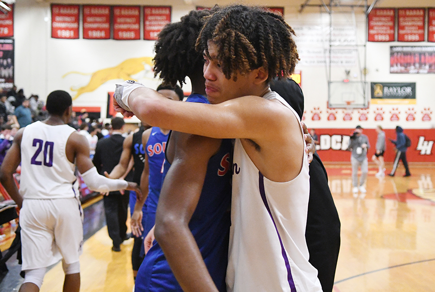 Senior Xavier Elam gets hugged and congratulated on a great season by a South Garland opponent after losing 70-56 first round playoff loss. Photo by Chad Byrd