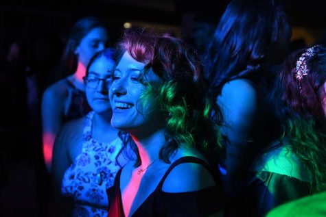 Junior Samantha Vassen laughs as the neon lighst flash at homecoming. “I went freshman year and back then I was more antisocial and just played video games, but this year I just wanted to be myself and dance and not care what anyone else thought. I had lots of fun with friends,” said Vassen.