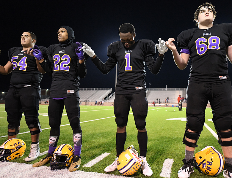 Varsity football players Kain Perez, Michael Gilmer, Stone Carter and Drew Moss stand for the alma mater after losing the final game of the season to Lake Highlands. Photo by Chad Byrd Photo credit: Chad Byrd