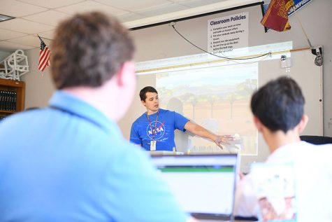 Physics teacher Derek Hammons explains gizmos activity, a lesson where students interact on their computers and follow along with the board, on his last day as an RHS teacher before leaving to work for NASA. Photo by Chad Byrd.