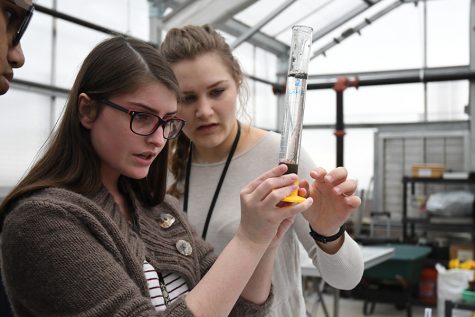 Seniors Alexis Koladycz and Sarah Jackson measure soil in the new greenhouse. “We were trying to determine the quality of the soil,” Koladycz said. It was really cool because you dont think about soil having so many qualities, but there are actually a ton.” Talon photo by Lea Von Toerne