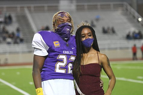 Senior Mya Johnson stands with Senior Marcellus Dennis after being named homecoming queen. Mya was crowned at the MacArthur home game to make up for missing the homecoming game after being contact traced. Talon Photo by Mallory Derrick Photo credit: Mallory Derrick