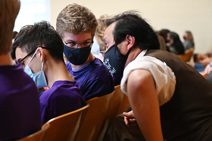Esports Adviser Henry Vo and Overwatch Captain Greg Smith whisper to each other before the school board recognizes the team for their victory at Nationals. Talon Photo by Shea Southern