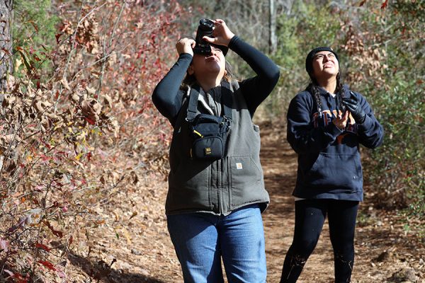 Seniors Katherine Mejia and Valeria Orellana hike while capturing images in the forrest for the camping trip photography contest for the communications magnet. 
“We had a list of things to capture, like a scavenger hunt,” Mejia said. “We found a really cool bird nest and we took pictures of it.