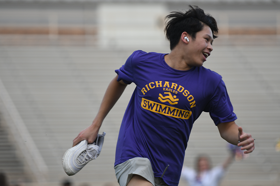 Not even five seconds later, Dai started to lose his balance, causing his shoe to fly into the air, landing on the ground behind him soon after Dai himself. His teammates ran past him, barely able to contain their laughter as Dai ran back to grab his shoe before proudly limp-sprinting off the football field with one shoe on.

"We all knew he was going to trip from the beginning," RHS swim team member Megan Tu said. "But seeing it actually happen was really funny."