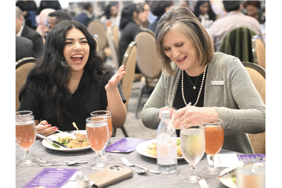 Senior Gabriela Vicente chats with Omni Dallas Hotel Managing Director Carolyn Dent at an event held in the Library.  
“They came down to help us with the banquet ceremony that we held in the library,”
Vicente said. The Hotel Management class partnered with the Omni to renovate their classroom to simulate a hotel lobby.