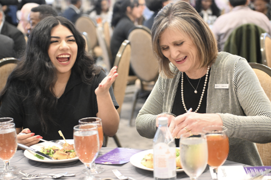 Senior Gabriela Vicente chats with Omni Dallas Hotel Managing Director Carolyn Dent at an event held in the Library.  
“They came down to help us with the banquet ceremony that we held in the library,”
Vicente said. The Hotel Management class partnered with the Omni to renovate their classroom to simulate a hotel lobby.