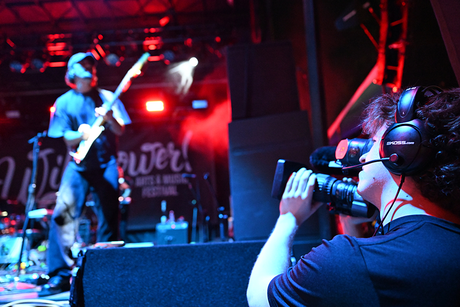 Communications junior Connor Coalson filming singer at Wildflower. Talon photo by Henry Fair. 