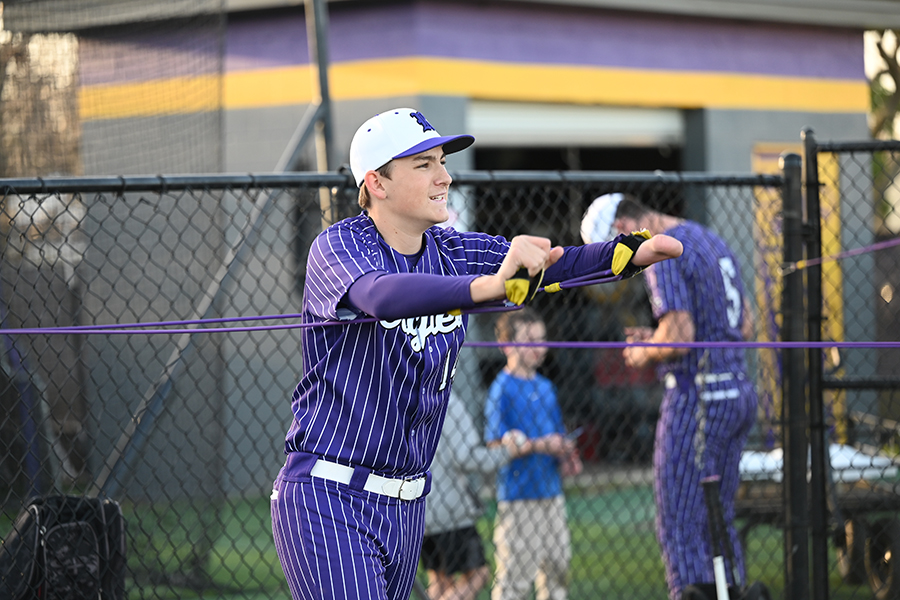 Senior varsity baseball player John Potter goes through warmup exercises before their game against Irving High School. Talon photo by Henry Fair
