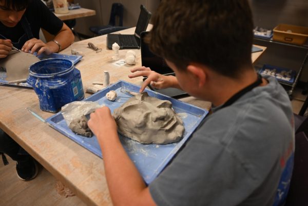 Junior Evan Justin-Phillips sculpts the eyes of his German cultural mask for Ceramics 1. Talon photo by Ilan Ahmed. 