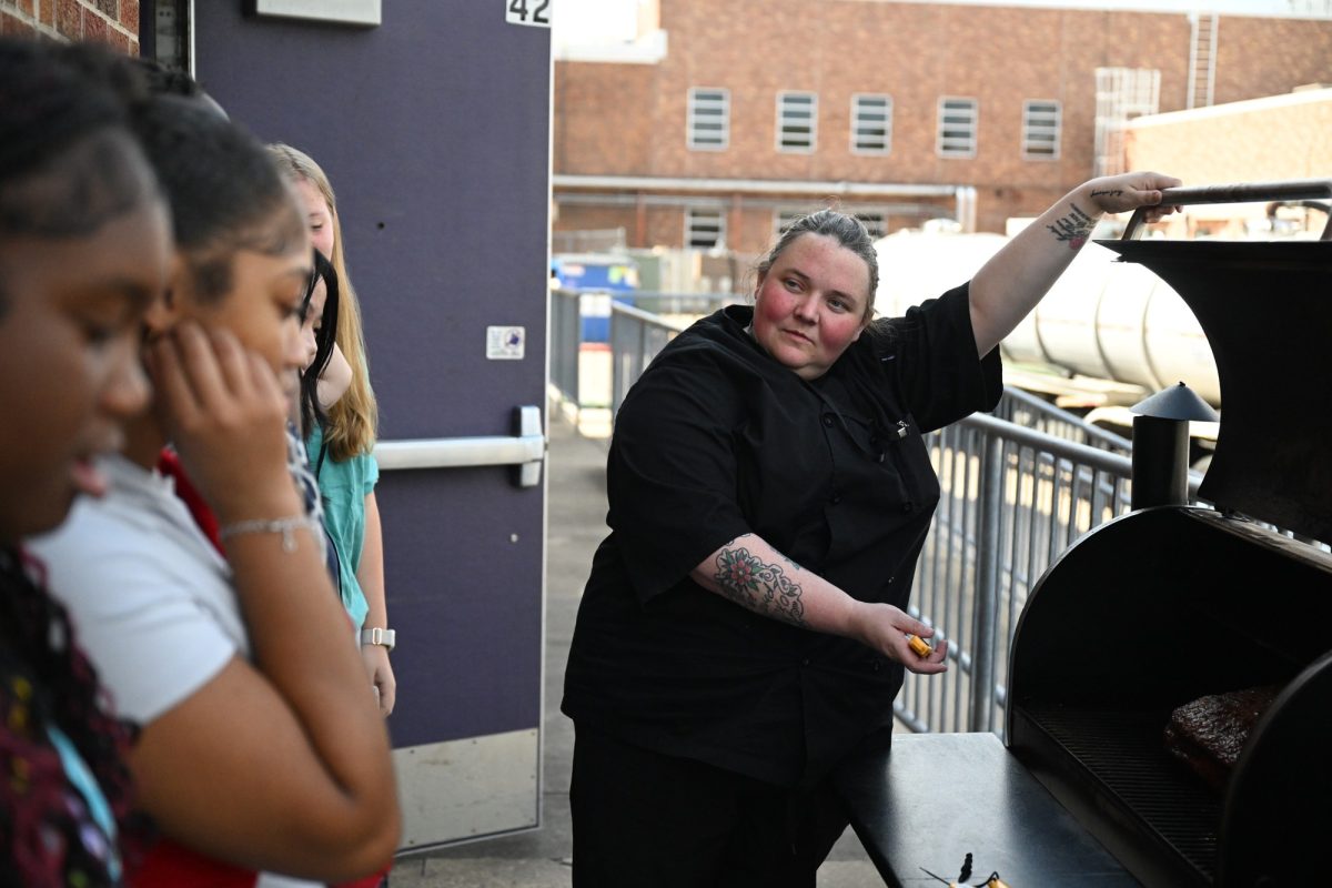 Chef Meredith Gann shows her intro to culinary students how to smoke a brisket on a Traeger for their Grab-and-Go on Thursday. Gann is the new culinary magnet teacher this year, bringing 14 years of industry experience and 6 years of teaching to students. Talon photo by Porter Pace