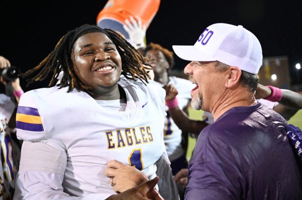 After beating Pearce, senior Jai'meon Winfield celebrates with principal Chris Choat after dumping a jug of water on him. It was the first time since 2015 the Eagles beat the Mustangs, holding them to 195 yards. Next up will be Jesuit College Prep this Friday at Ranger Stadium. "Last year, we came up short, but this year we knew what to do," Winfield said. Talon photo by Ray Brosnahan.