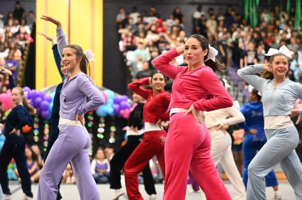 At the fall pep rally, senior Mirabelle Fooshee performs a student-led routine she helped choreograph to “Maria” by Justin Bieber alongside the jv and varsity cheerleaders. Senior cheer captains Kaelei Patterson and Purity Macharia choreographed the cheer team’s pep rally routine with help from senior game day captains Mirabelle Fooshee, Mia Ortiz and Abigail Blum. "We all just collaborate together and make a dance that's really good and deserves cheer dancers," Fooshee said. Talon photo Ray Brosnahan