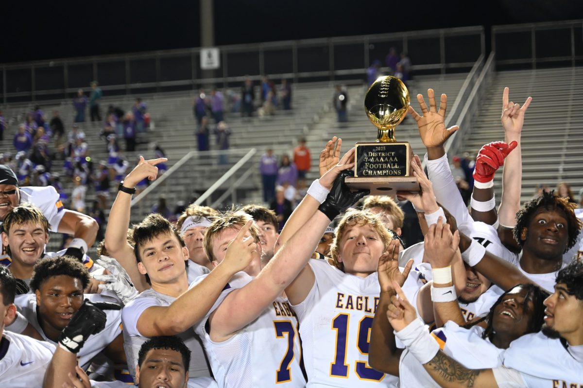 Senior quarterback Lucas Sawyer holds up the district title trophy with the rest of the varsity football team after beating MacArthur 42-7. It was the first time the team had won the district title in over 20 years. Next up is their playoff game against Haltom High School on November 14. "It feels great, and we deserve it," Sawyer said. "I feel like we've been working for a very long time, and it's been a long time coming, but I'm super excited."