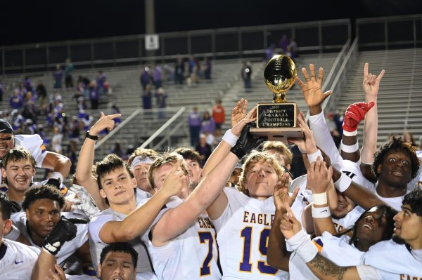 Senior quarterback Lucas Sawyer holds up the district title trophy with the rest of the varsity football team after beating MacArthur 42-7. It was the first time the team had won the district title in over 20 years. Next up is their playoff game against Haltom High School on November 14. "It feels great, and we deserve it," Sawyer said. "I feel like we've been working for a very long time, and it's been a long time coming, but I'm super excited."