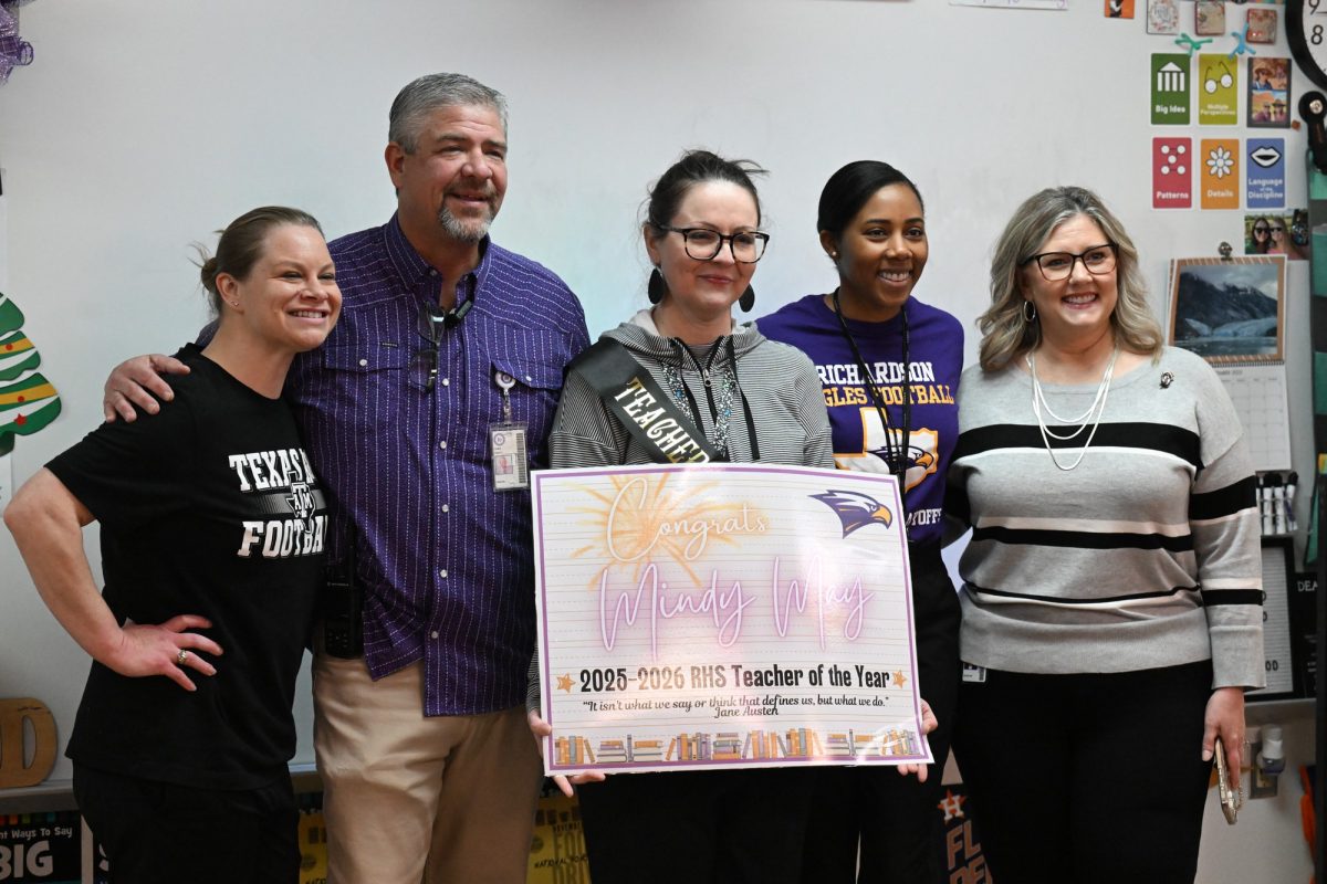 English teacher and department head Mindy May holds up the "Teacher of the Year" sign while posing for a photo with English teacher Elyse McKinney, Principal Chris Choat, Assistant Principal Cassie Stegall and Financial Assistant Tammy Rangel. May was award the Teacher of the Year of RHS today after being nominated and voted by the faculty. "I felt just really grateful to work in a place where people know who you are and they care enough about you to make those those recognitions of all that you do every day," May said. Talon photo by Hudson Morris