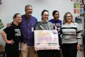 English teacher and department head Mindy May holds up the "Teacher of the Year" sign while posing for a photo with English teacher Elyse McKinney, Principal Chris Choat, Assistant Principal Cassie Stegall and Financial Assistant Tammy Rangel. May was award the Teacher of the Year of RHS today after being nominated and voted by the faculty. "I felt just really grateful to work in a place where people know who you are and they care enough about you to make those those recognitions of all that you do every day," May said. Talon photo by Hudson Morris