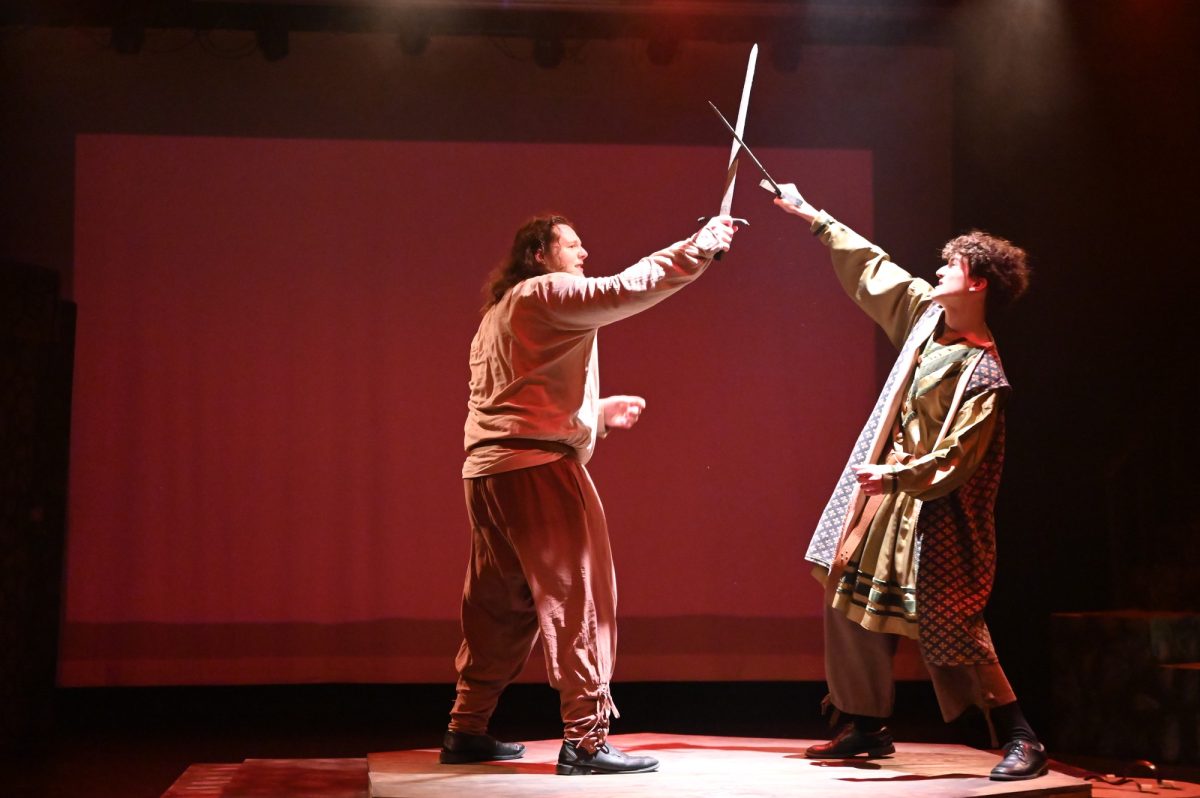 Junior Reiner Grantham, who plays Macbeth, strikes sophomore Clay Morgan, who plays Macduff, with his sword during the final battle scene of their dress rehearsal. The Theatre Collective included stage combat for the first time in their Halloween production of "Macbeth." The show ran from October 30 through November 1. Talon photo by Xaviar Sheehan