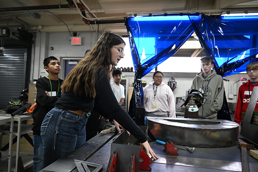 Robotics Magnet junior Madison Frischhertz shows her welding project to the eighth graders to promote the Robotics Magnet. Talon photo by Henry Fair