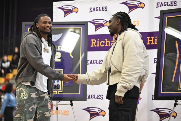 Alumni and NBA players Cason and Keaton Wallace shake hands after officially retiring their jerseys. Cason and Keaton came back to RHS on February 13 for a ceremony retiring their jersey numbers to honor their success in the NBA and the impact they made on the school’s basketball program. "It always feels good to be back," Keaton said. "This is where it all started for us." Talon photo by Xaviar Sheehan