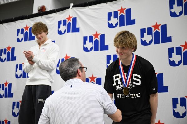Senior Graham Rittiluechai receives a bronze medal for the boys one meter dive at the UIL Swimming & Diving State Meet with a score of 509.35. He is the first recorded diver from RHS making the state podium. "I'm so happy to bring home some hardware," Rittiluechai said. Talon photo by Henry Fair