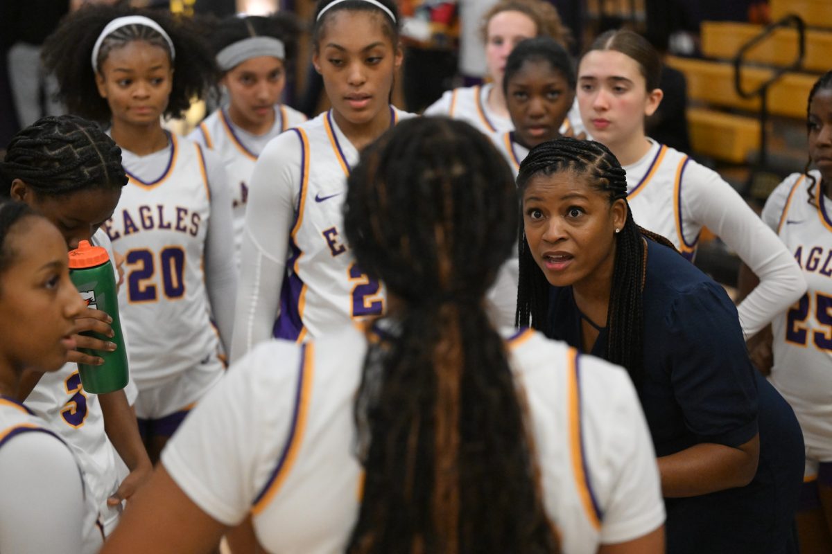 Head Girls Basketball Coach Kelly Dansby huddles up with her team during the game against Nimitz High School. Dansby achieved her 200th career win against Nimitz High School as a varsity head coach after 16 years of coaching. "Just to be able to share it with this team, staff, and community – its just a privilege to be able to coach these girls," Dansby said. Talon photo by Xaviar Sheehan