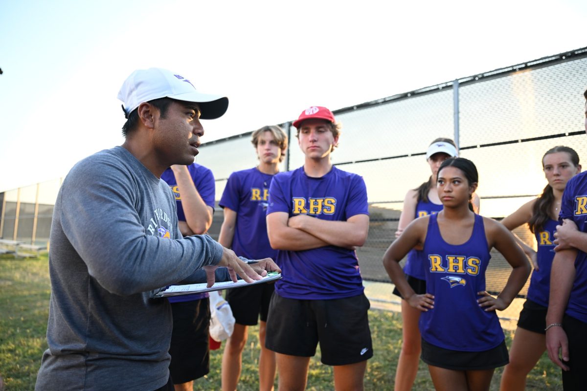 The varsity tennis team huddles around tennis coach William Manhkong during the bi-district tournament. The varsity tennis team has a new tradition this year where they eat at a restaurant together after every meet to create a team bond. "It's nice to be able to talk after a match," senior varsity tennis player Austin Tipay said. "Just be able to sit and laugh with my close friends." Talon photo by Henry Fair