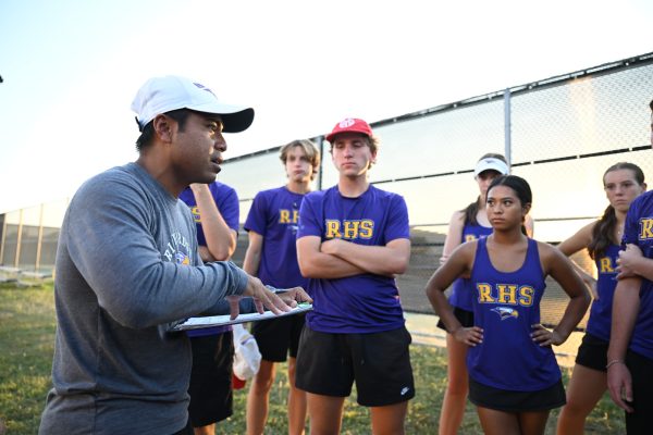 The varsity tennis team huddles around tennis coach William Manhkong during the bi-district tournament. The varsity tennis team has a new tradition this year where they eat at a restaurant together after every meet to create a team bond. "It's nice to be able to talk after a match," senior varsity tennis player Austin Tipay said. "Just be able to sit and laugh with my close friends." Talon photo by Henry Fair